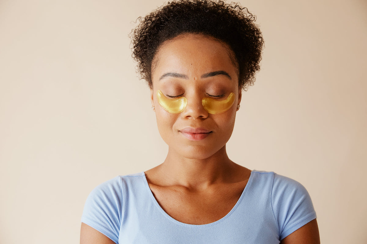 Woman with under-eye patches in a calm skincare moment